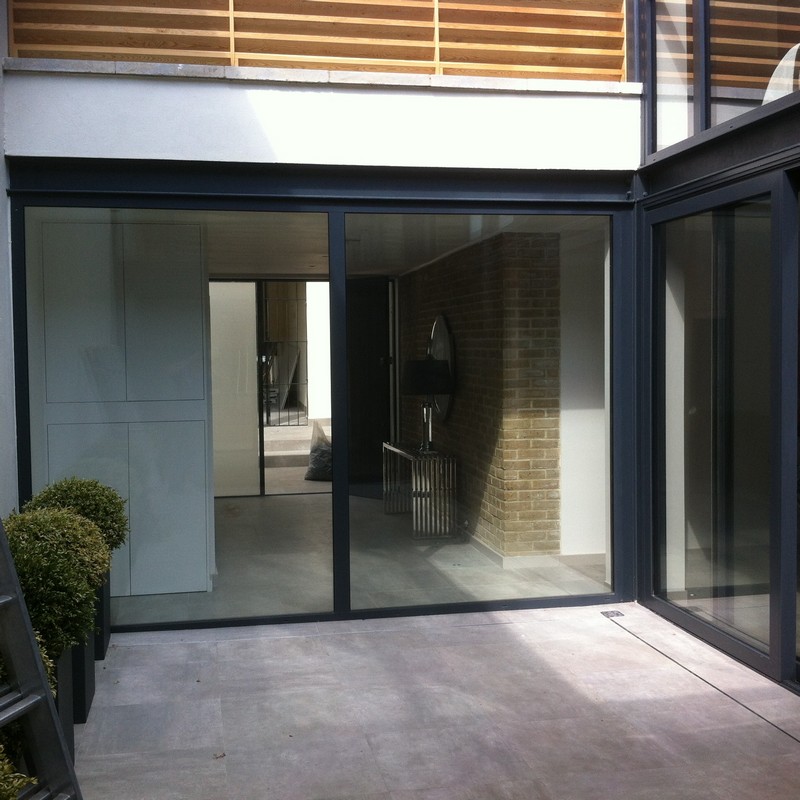 Floor-to-ceiling sliding doors opening to courtyard in Leytonstone