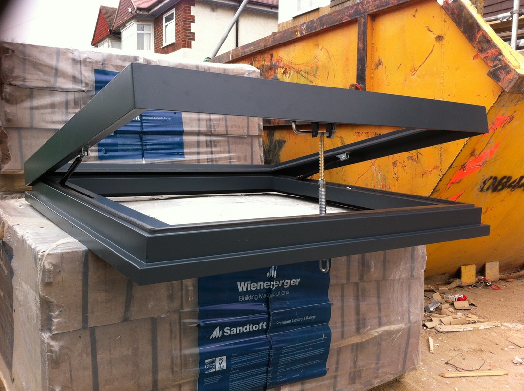 Opening flat roof skylight in anthracite grey installed in Leytonstone
