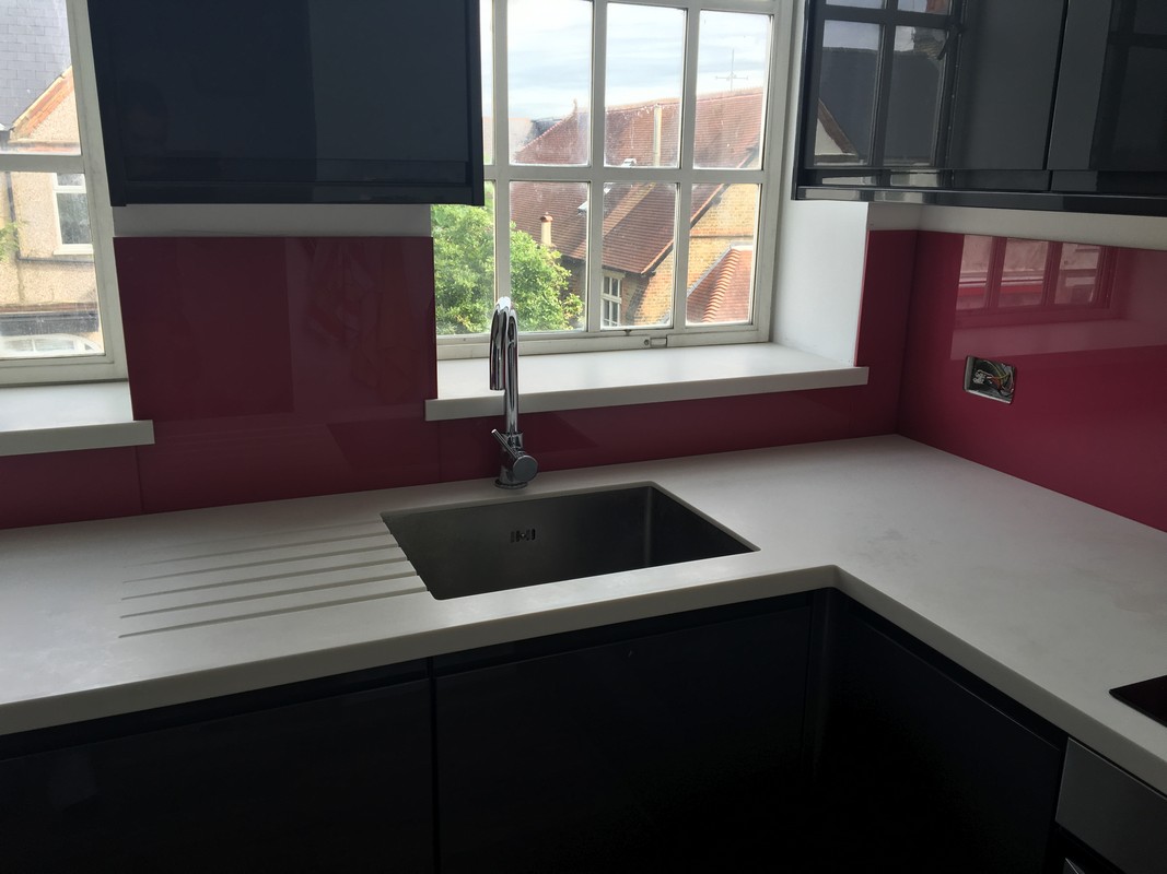 Deep plum coloured glass splashback in modern Leytonstone kitchen